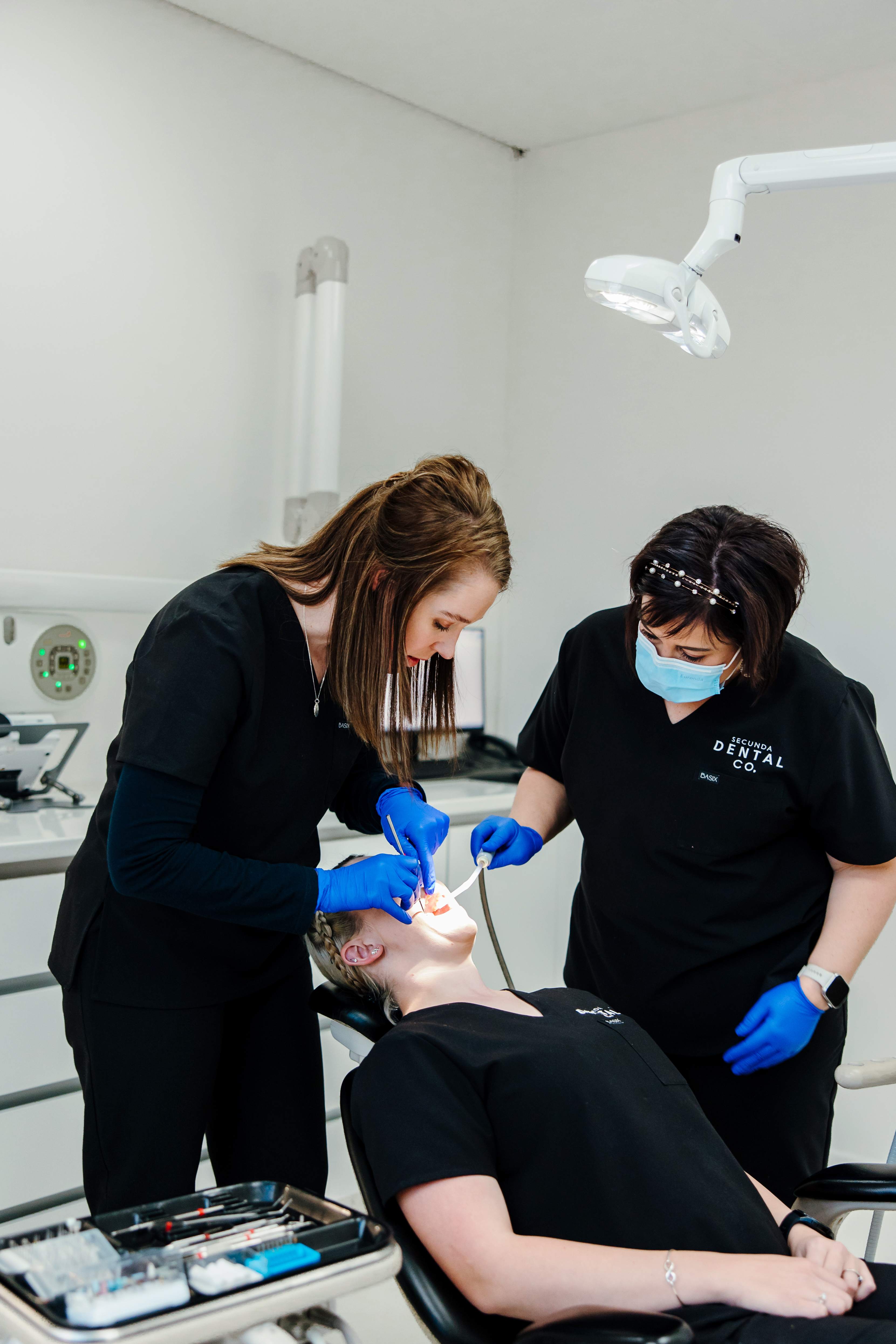 Dental professionals working on patient treatment