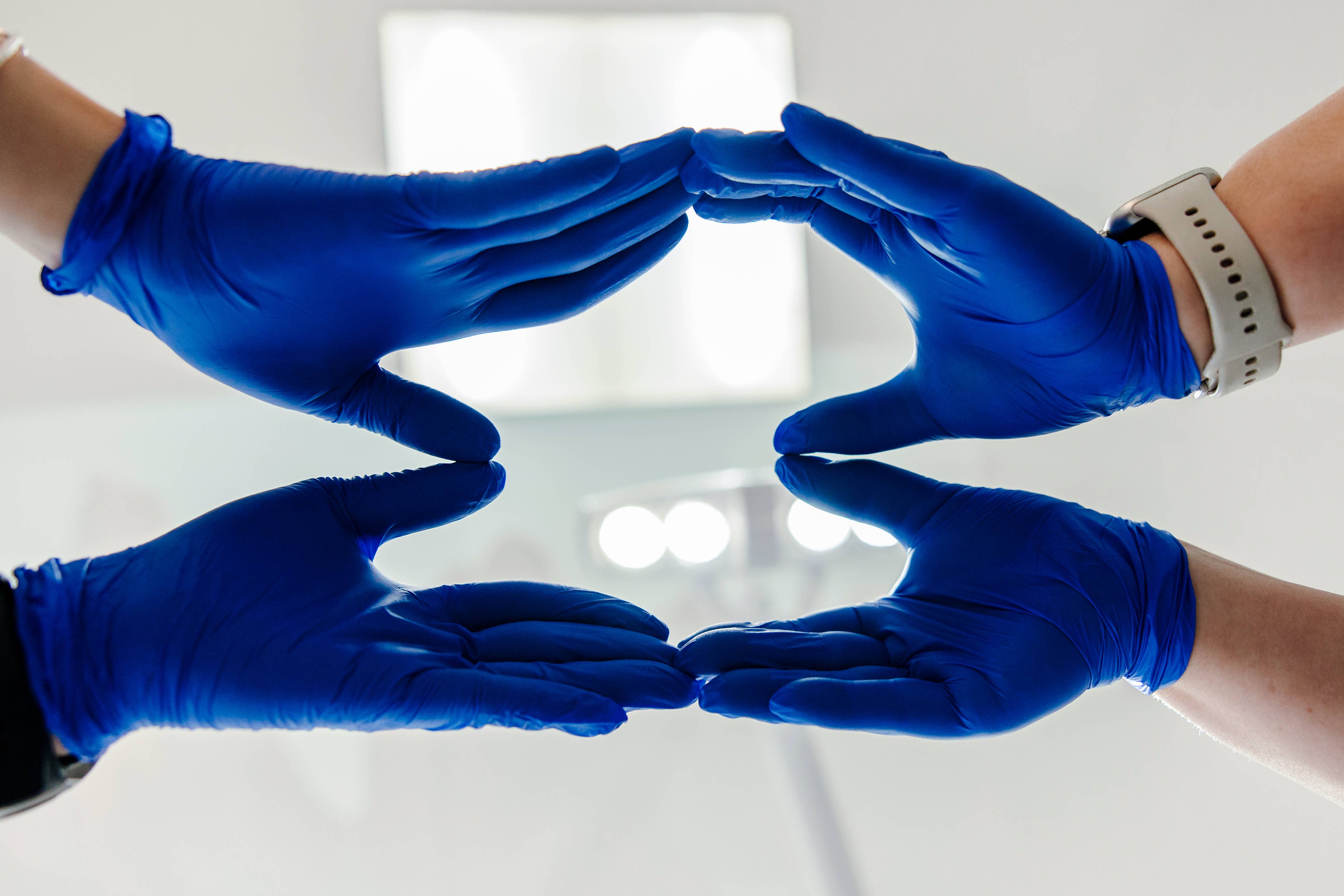 Protective hands gesture in blue gloves